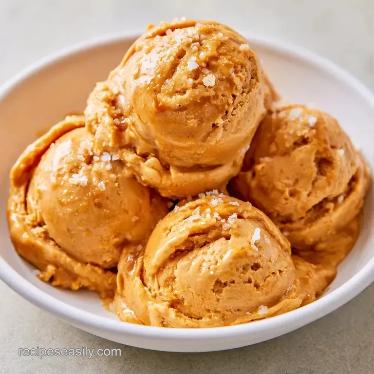 Pale gold scoops in a crystal coupe glass, drizzled with rich amber syrup and topped with flaky sea salt.